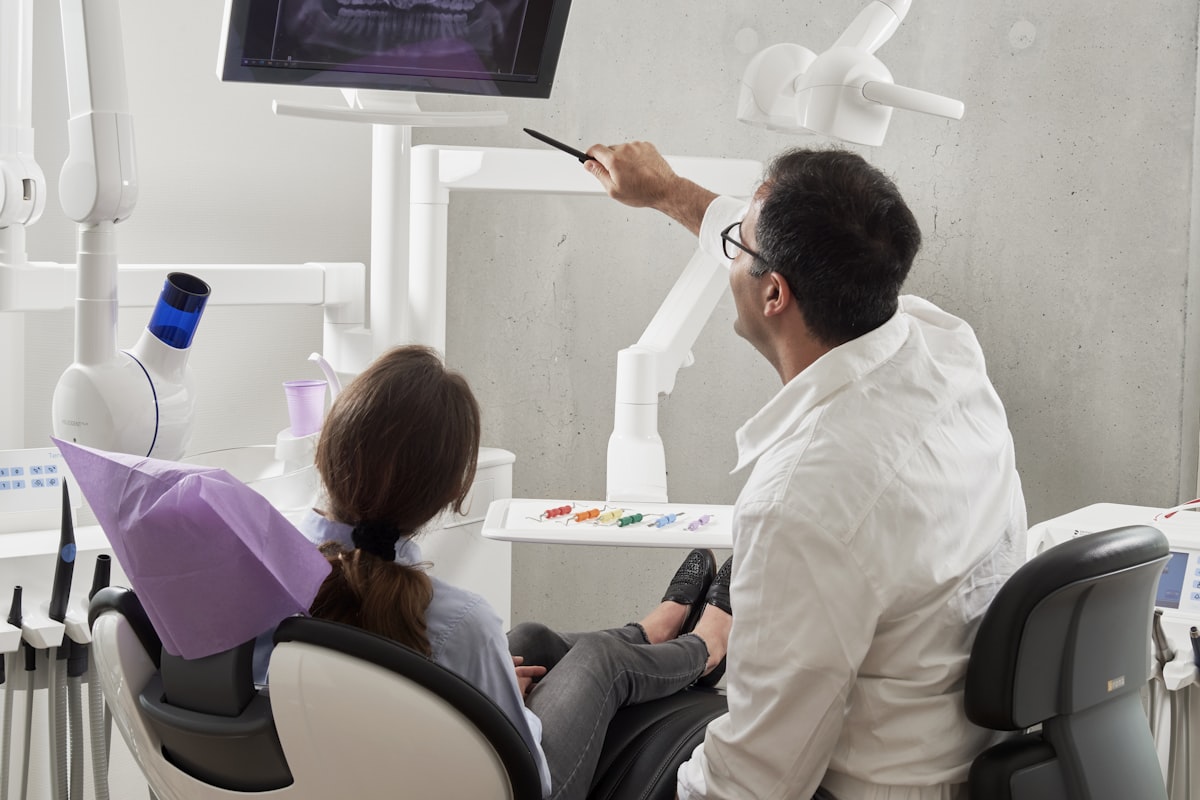 A dentist talking a patient through their treatment plan